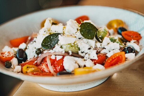 Traditional Greek salad with tomatoes, cucumbers, olives, and feta cheese at Naxaki Beach Lounge Restaurant in Naxos