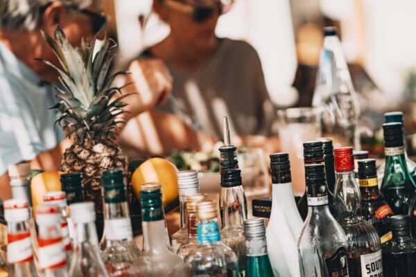 A close-up of the bar area at Naxaki Beach Lounge Restaurant, showcasing various drinks and a pineapple