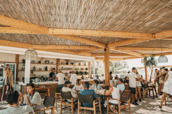 Guests dining near the bar area at Naxaki Beach Lounge Restaurant