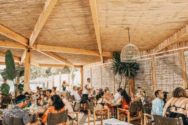 Spacious dining area at Naxaki Beach Lounge Restaurant filled with guests