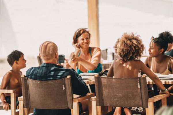 A family dining together at Naxaki Beach Lounge Restaurant, capturing a joyful moment