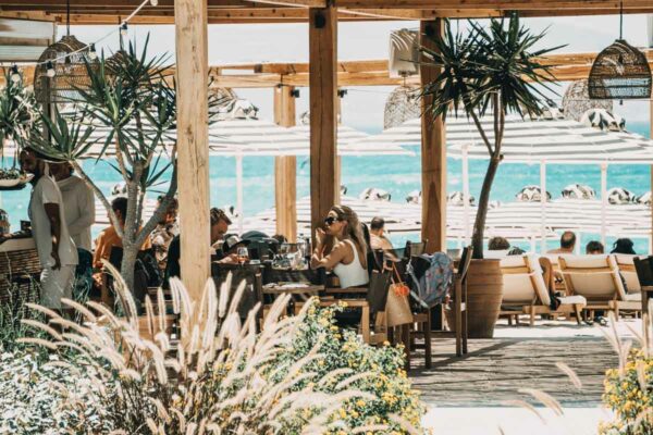 Guests enjoying oceanfront dining at Naxaki Beach Lounge Restaurant