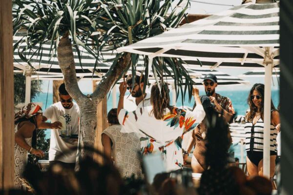 Guests dancing and enjoying an outdoor party at Naxaki Beach Lounge Restaurant.