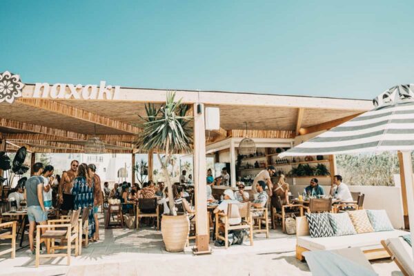 Entrance view of Naxaki Beach Lounge Restaurant with guests socializing