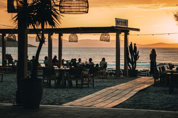 Sunset view from Naxaki Beach Lounge Restaurant with guests enjoying the evening