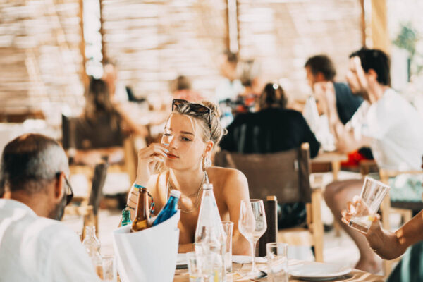 A young woman enjoying her meal at Naxaki Beach Lounge Restaurant