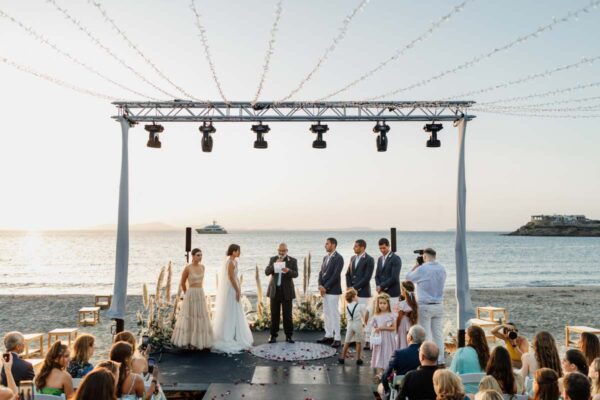 Wedding ceremony setup on the beach at Naxaki Beach Lounge and Restaurant, with a beautiful ocean backdrop and elegant decorations