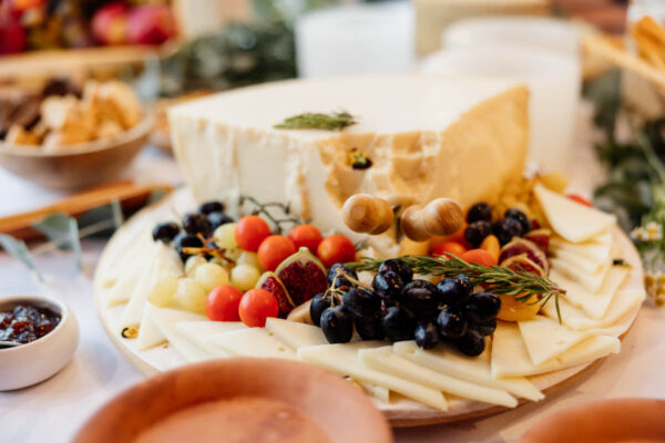 Close-up of a delicious cheese platter with fruits and nuts served at a wedding reception at Naxaki Beach Lounge and Restaurant