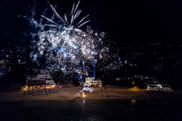 Spectacular fireworks display over Naxaki Beach Lounge and Restaurant during a wedding celebration