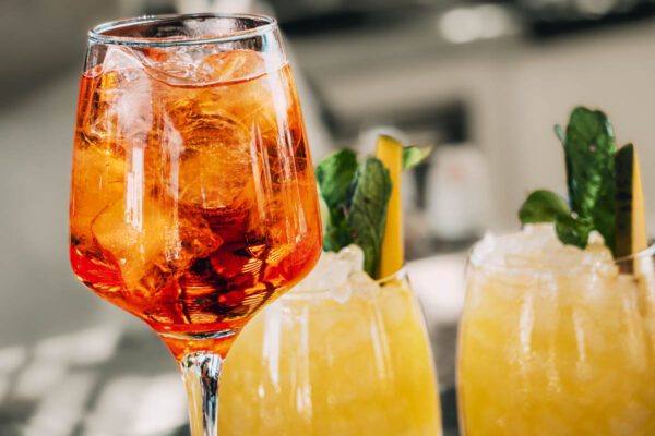 Refreshing Aperol Spritz and signature cocktails with mint leaves at Naxaki Beach Lounge Restaurant in Naxos