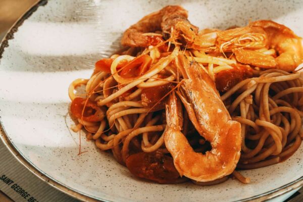 Delicious seafood pasta with shrimp and rich tomato sauce at Naxaki Beach Lounge Restaurant in Naxos