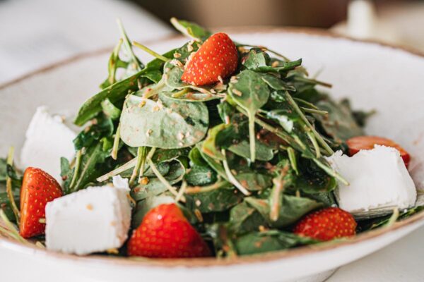 Fresh spinach and strawberry salad with goat cheese at Naxaki Beach Lounge Restaurant in Naxos